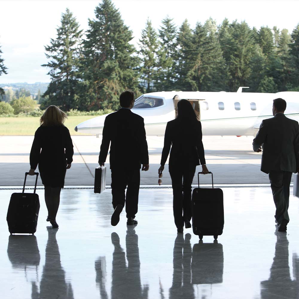 Business people walking toward private plane