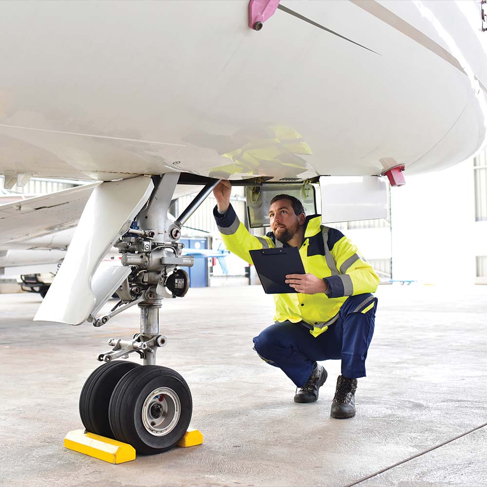 Lone Mountain employee performing aircraft maintenance
