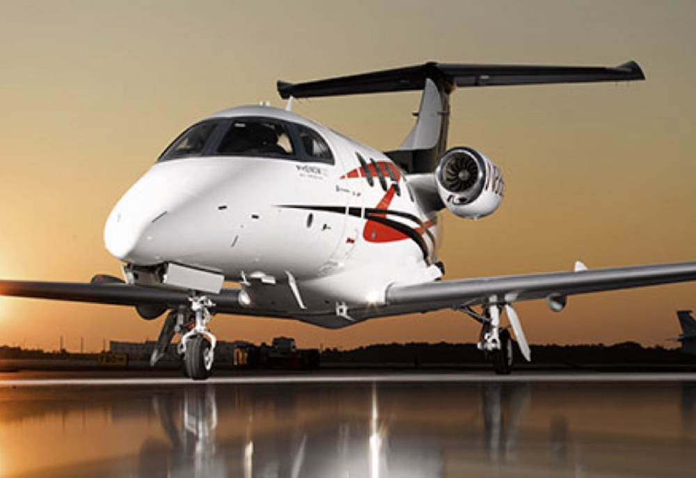private aircraft on tarmac at sunset