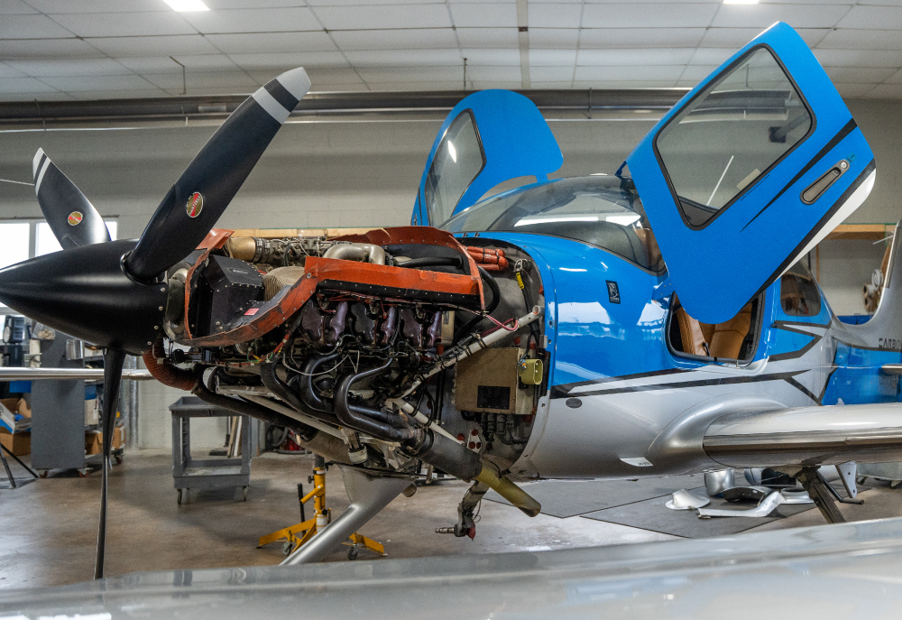 aircraft with engine exposed in shop
