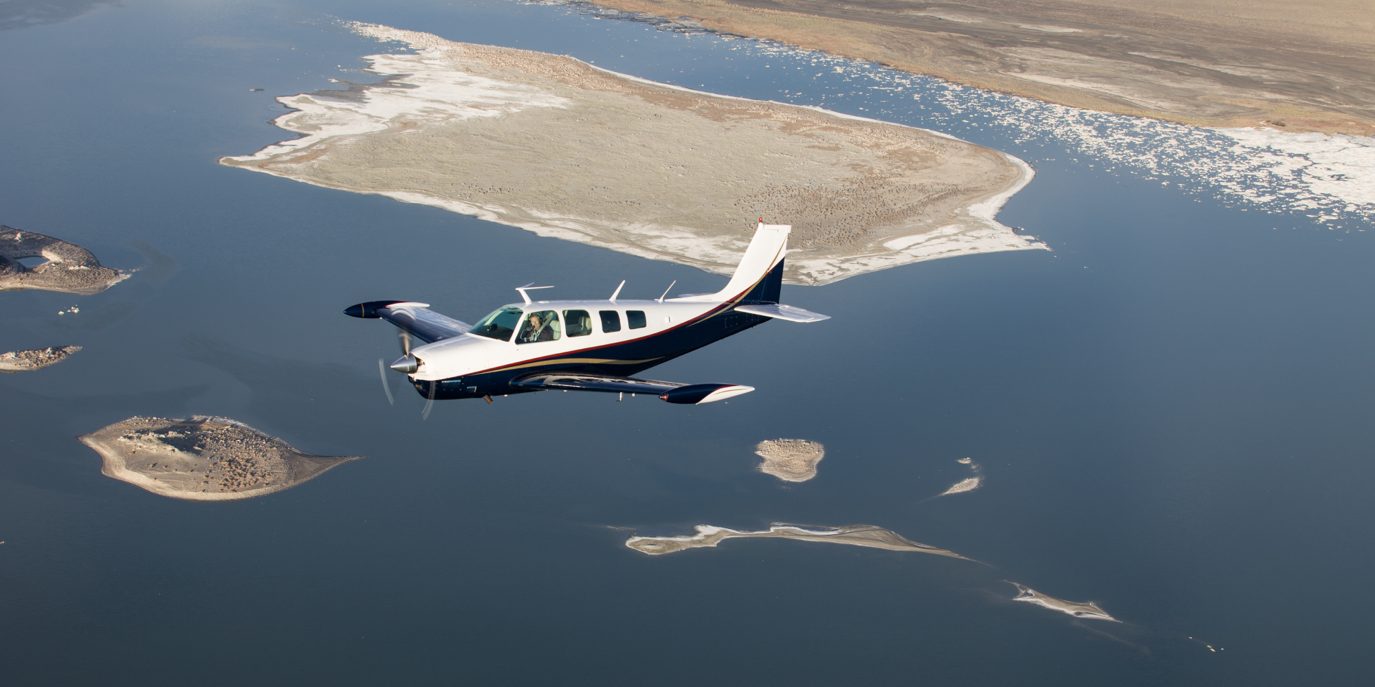 private aircraft flying over islands