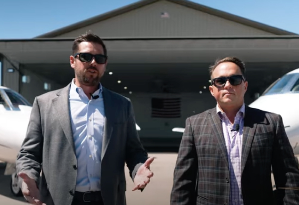 Lone mountain salesmen walking in front of hangar