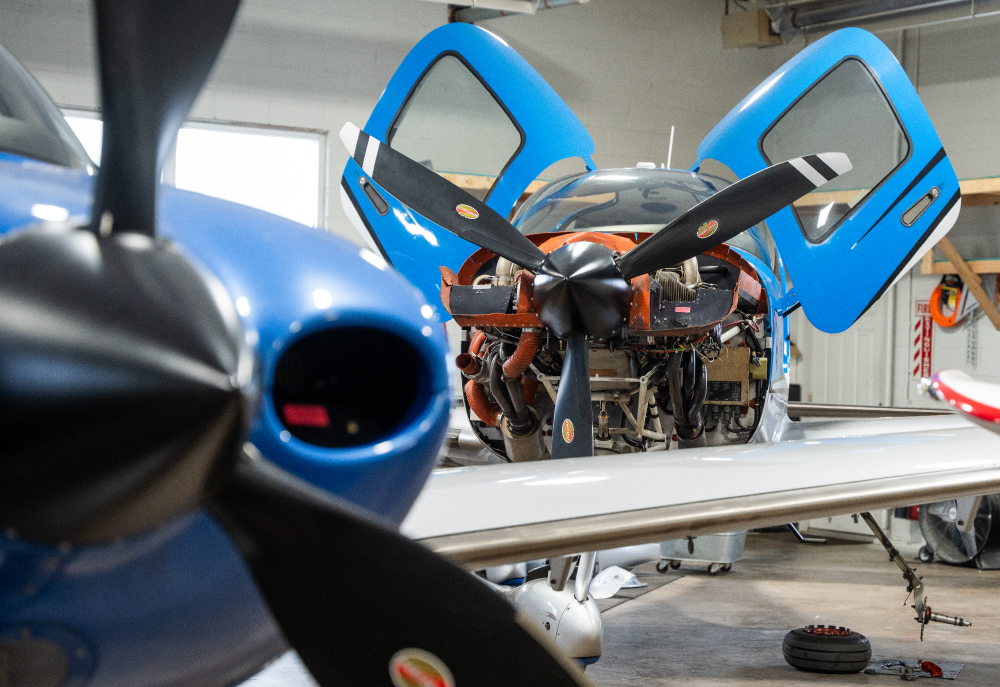 plane with engine exposed and doors open