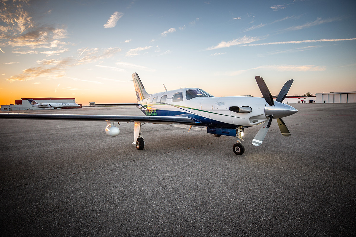 piper plane on tarmac at sunset