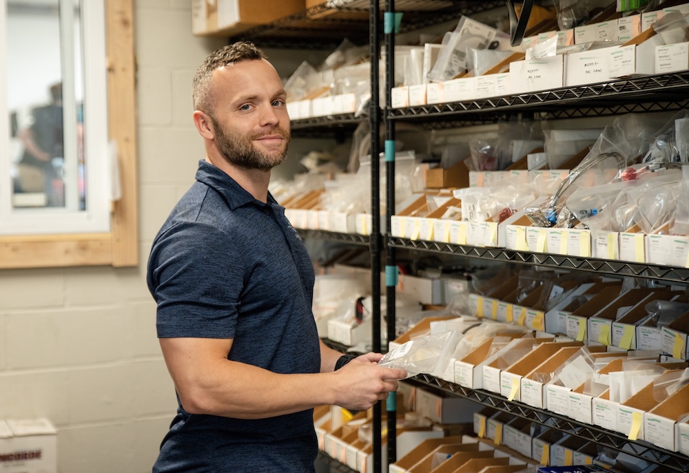 technician getting aircraft parts in a storage room